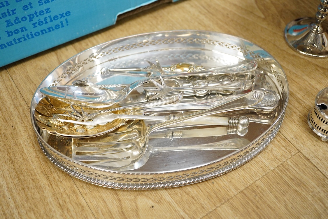 Assorted plated wares including a pair of candlesticks and a casserole dish.
